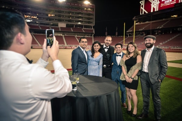 Man taking photos of group at stadium